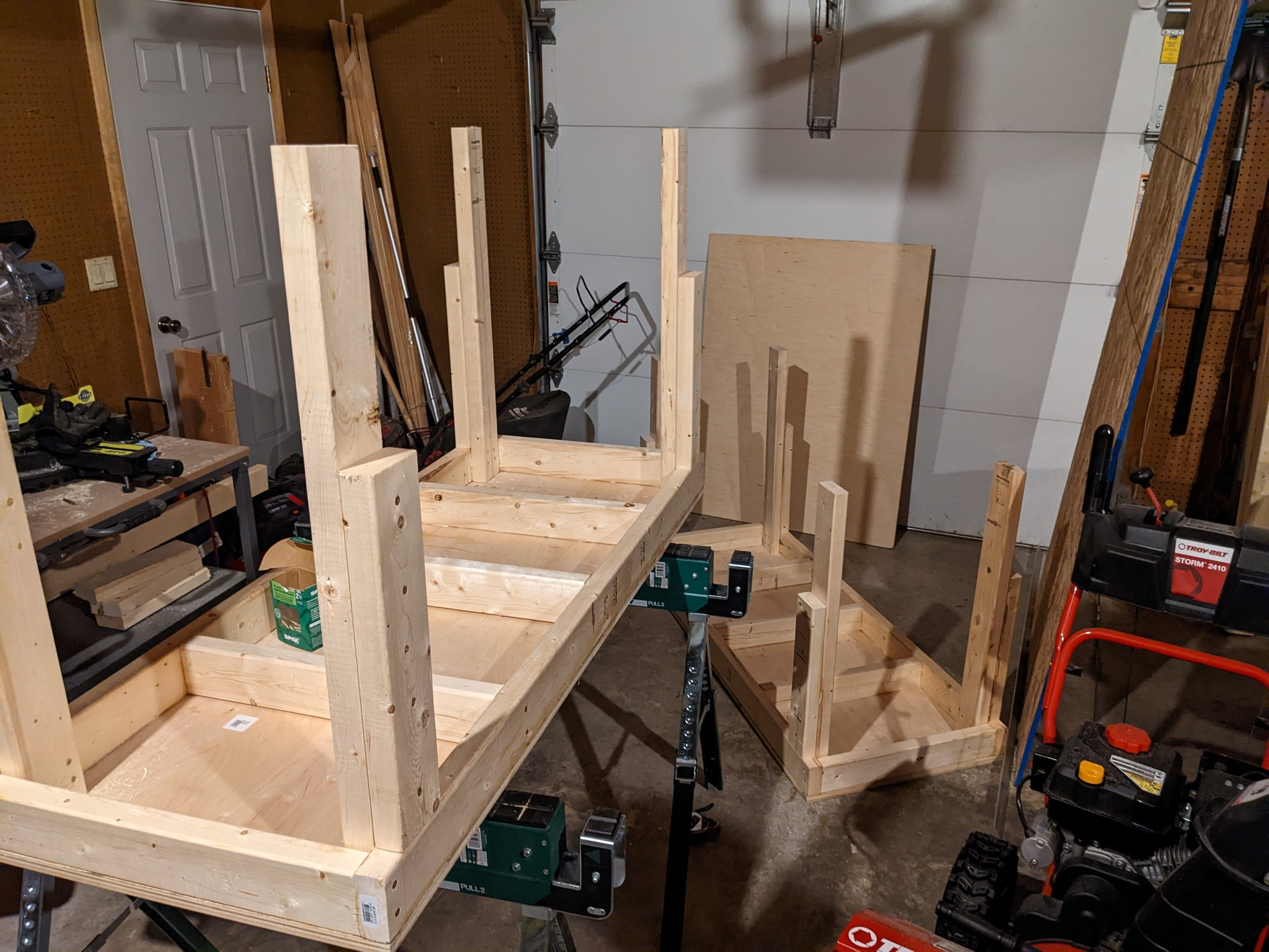 Two work tables on their tops with legs sticking up in the air.