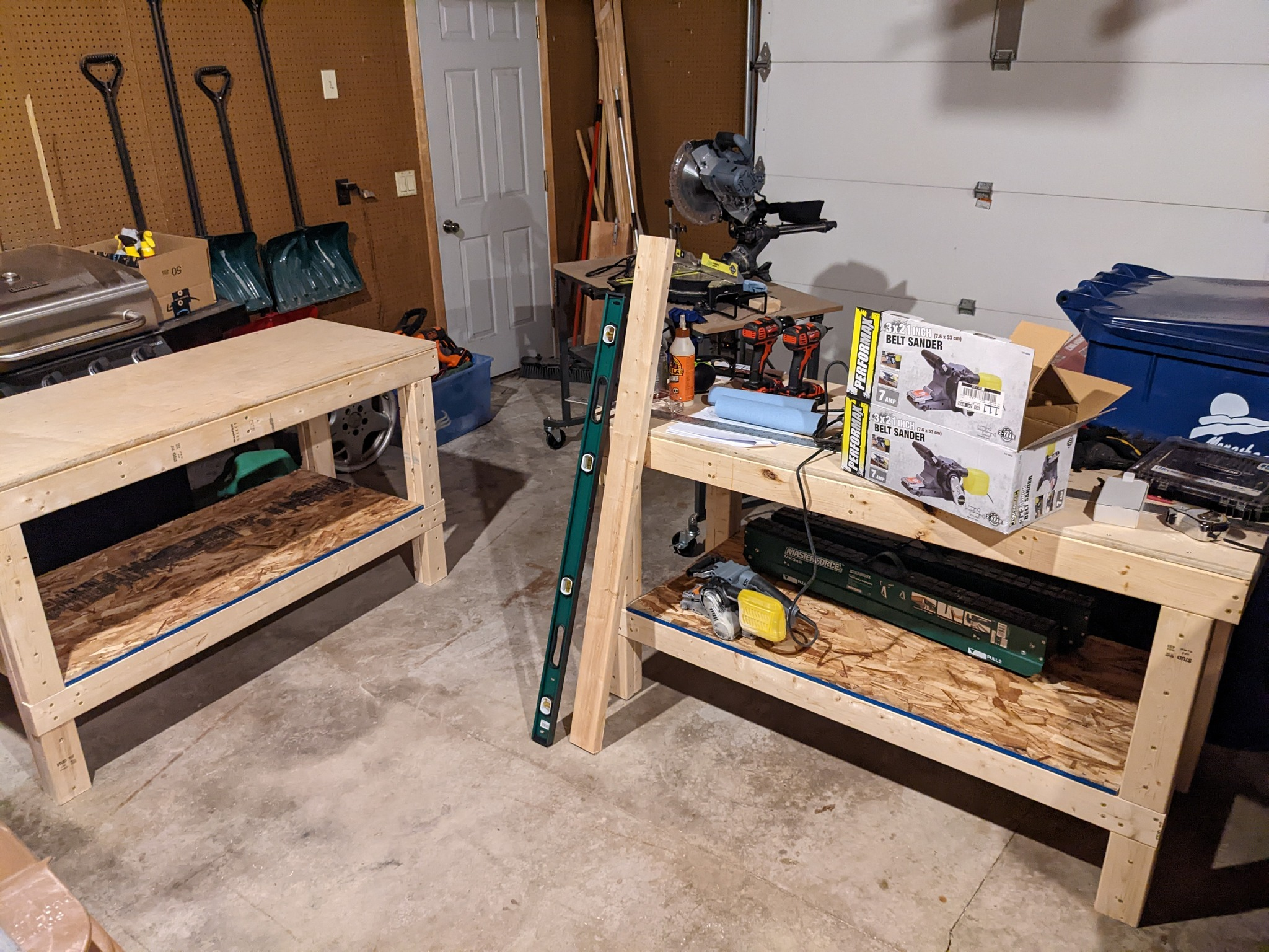 Two finished work tables sitting in a garage