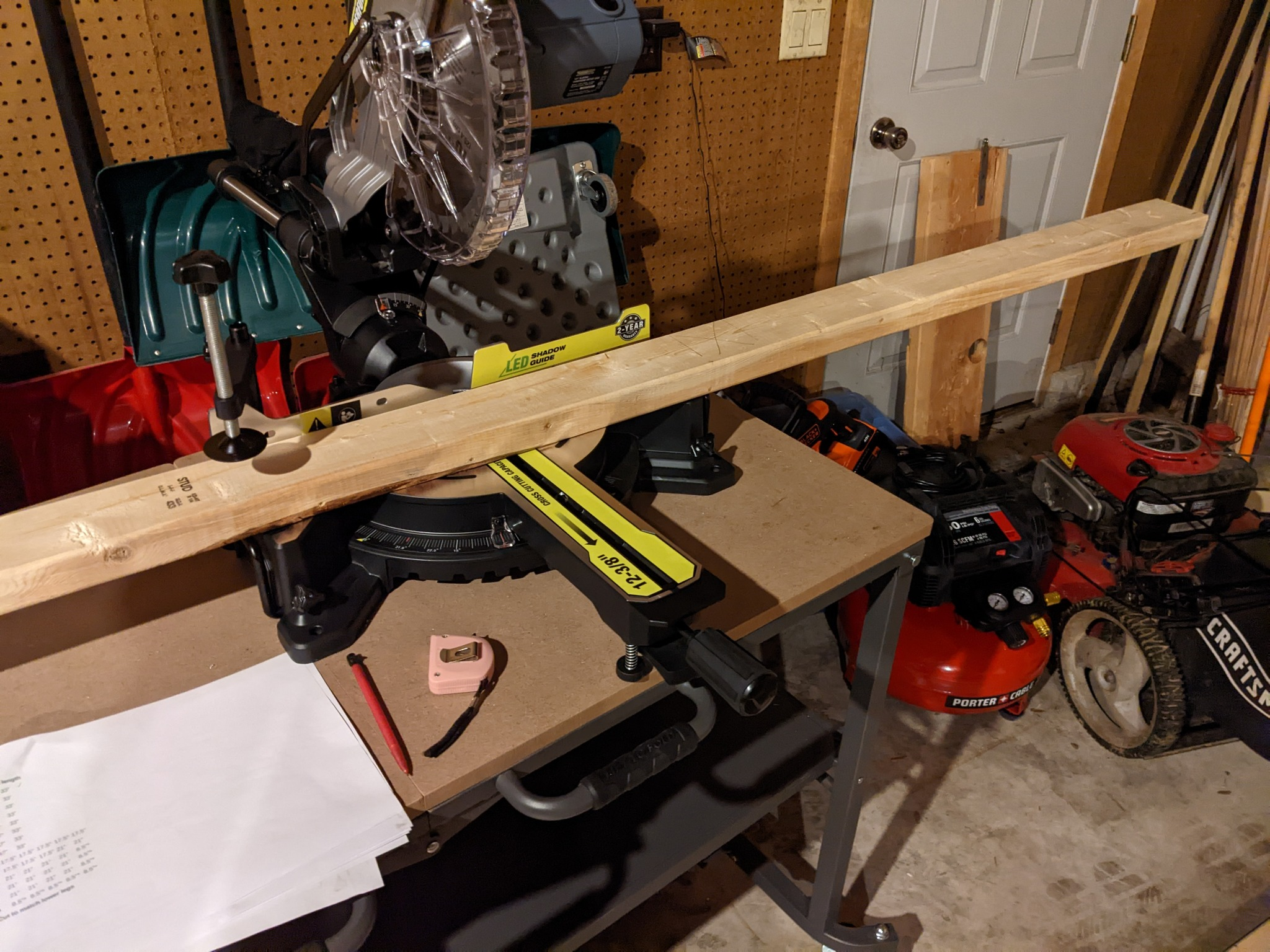 A 2x4 sitting on a miter saw