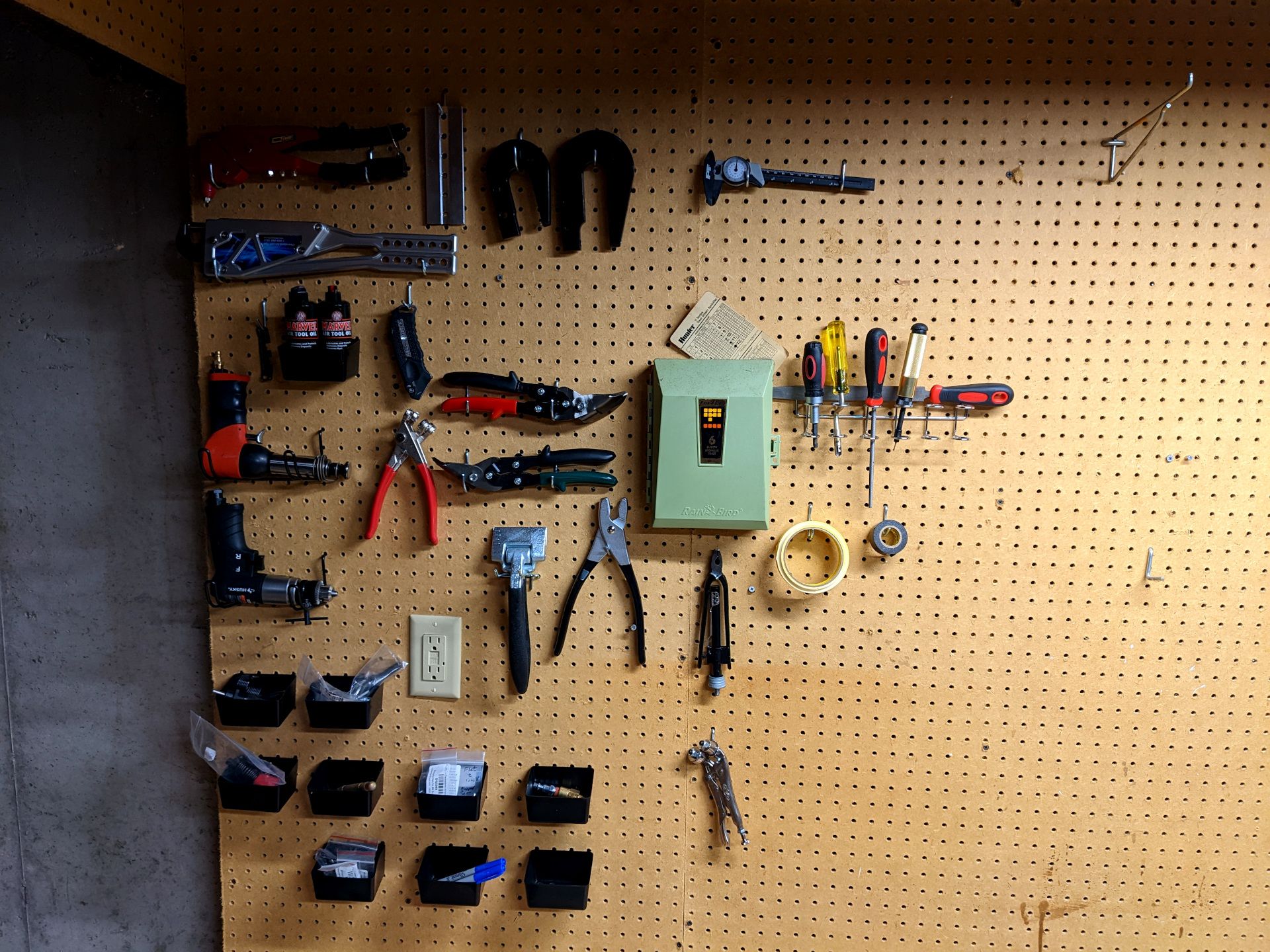 A section of the pegboard with various tools hung up