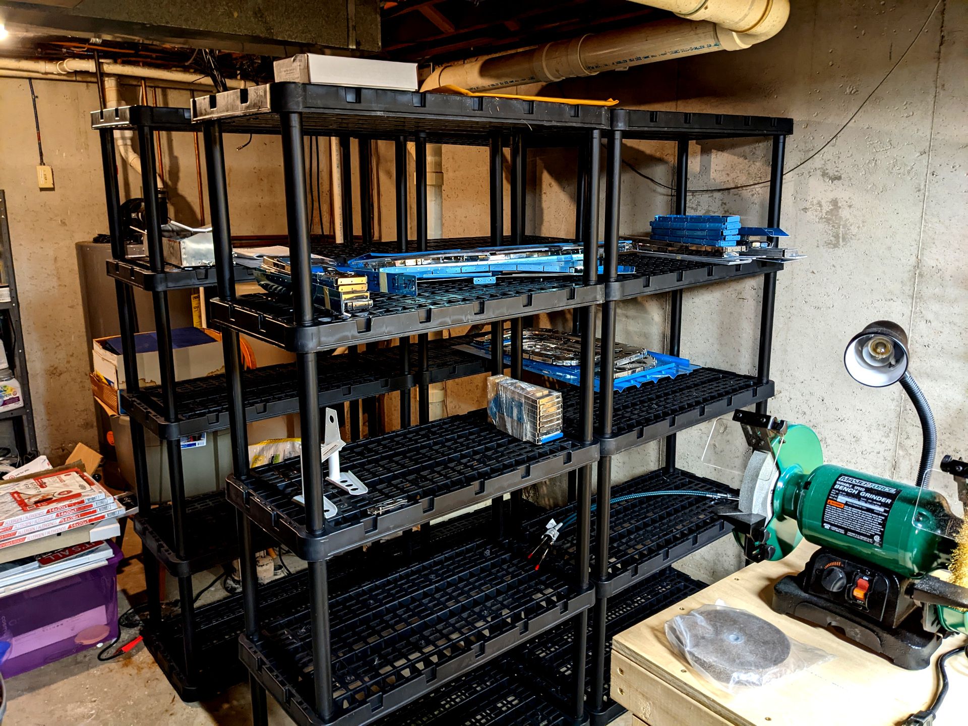 Four freestanding shelves with aluminum airplane parts on them