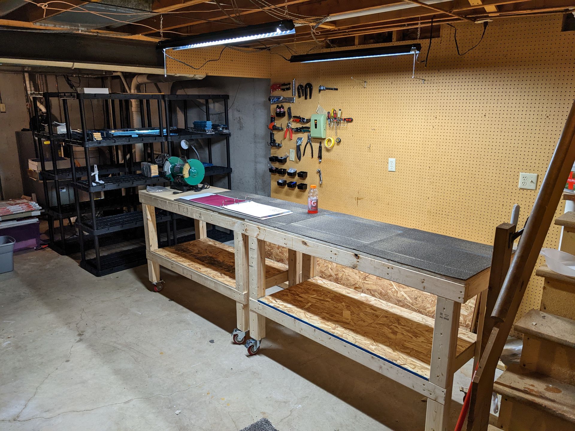 Final picture of the woork area. Pegboard filled, shelves places, work benches clean with carpet on top.