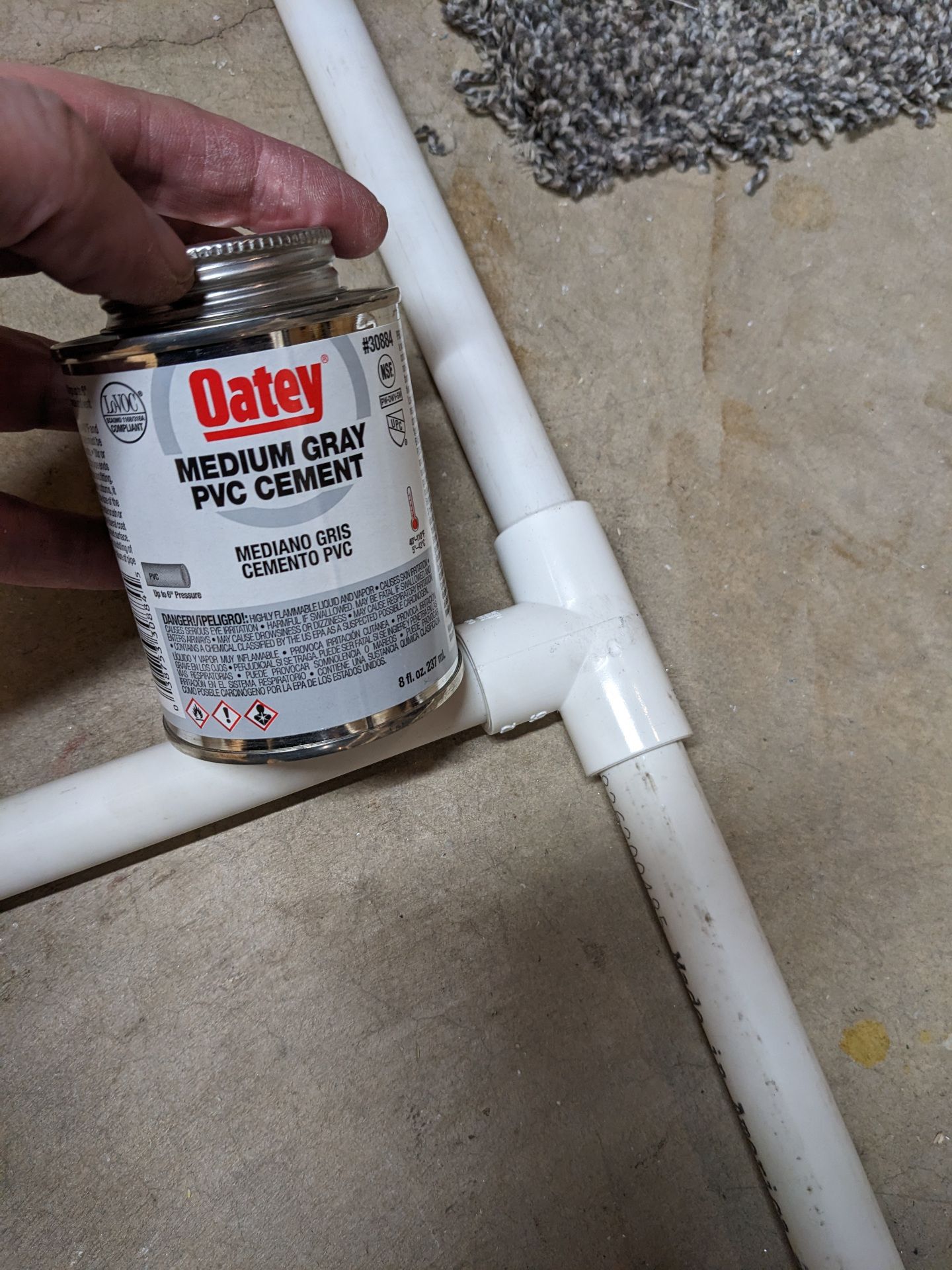 PVC cement next to some PVC pipe