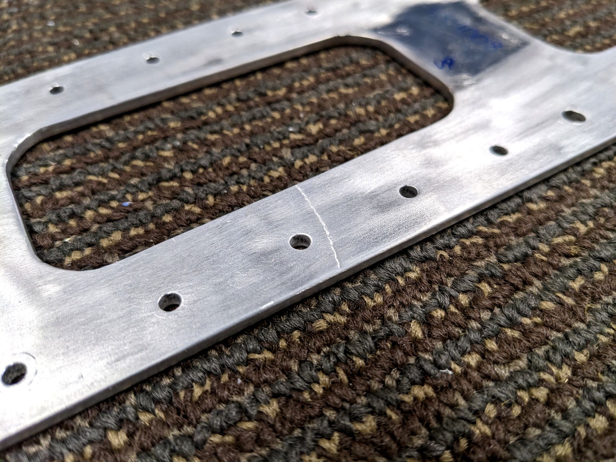 Aluminum part with scratch across surface