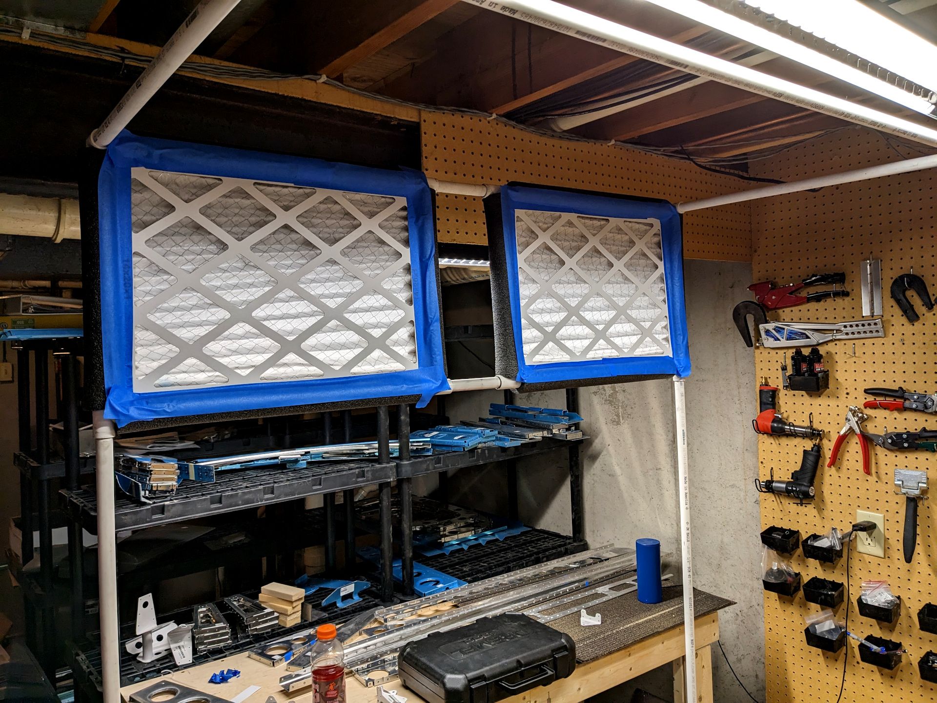 Intake filters on a pvc paint booth. They are taped in and surrounded by foam